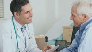 doctor talking to an elderly man